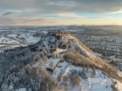 Aerial view of the snow-covered Hegau volcano Hohentwiel with Germany's largest castle ruins on a