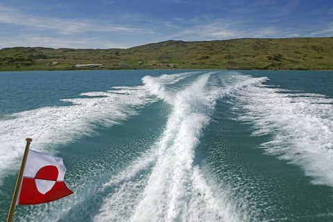 Boat trip on turquoise water with splashing waves and flag, Greenlandic flag, Narsarsuaq, Kujalleq,