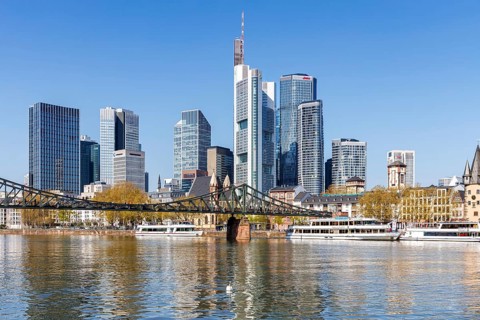 Frankfurt skyline skyscrapers with banks on the river Main with excursion boats and Eiserner Steg