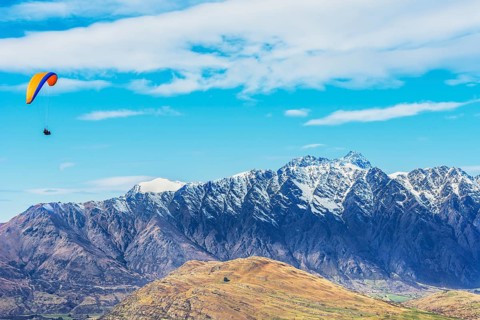 Paragliding over the Remarkables mountain range, Queenstown, South Island, New Zealand