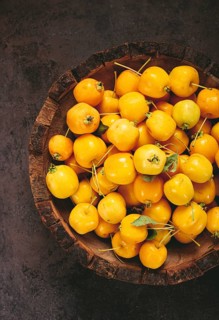 Yellow small apples, Chinese varieties, in a wooden bowl, top view, no people