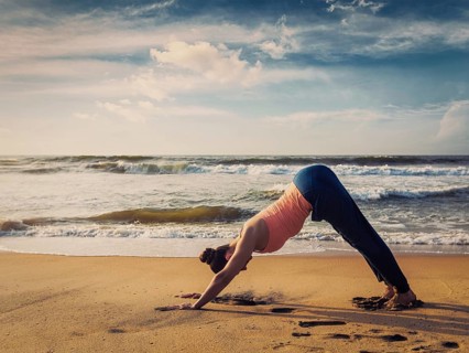 Vintage retro effect filtered hipster style image of Yoga outdoors, young sporty fit woman doing