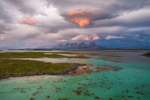 View of mountain range Seven Sisters from Herøy island, light mood, Helgeland coast, Nordland,