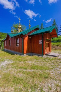 Building nexts to the wooden Greek-Catholic church of St. Nicholas in Bodružal, Slovakia