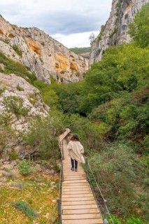 Woman walking on the path of the Vero river walkways in Alquezar. Huesca Pyrenees