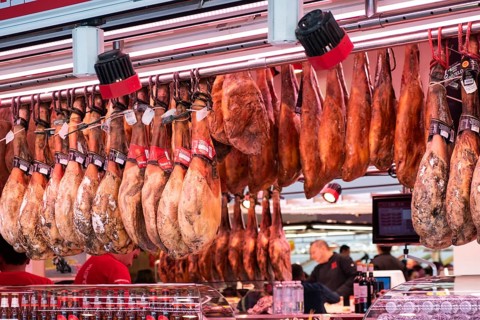 Market stall with sausage products at La Boqueria Market in Barcelona, Spain