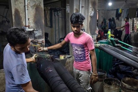 Worker in a denim dyeing factory, textile industry, Dhaka, Bangladesh