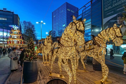 Light installation beer carriage with horses at Dortmund's Christmas market at dusk, Dortmund,