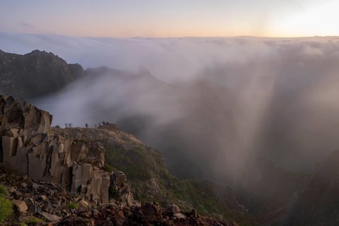 Sunrise at Pico do Arieiro, clouds of fog pass over mountain peaks, hiking trail PR1, Madeira,