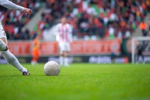 Detail of player's legs and the ball during soccer match
