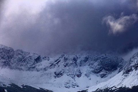 Shady mountains with snow under dark, threatening clouds, Ushuaia, Argentina