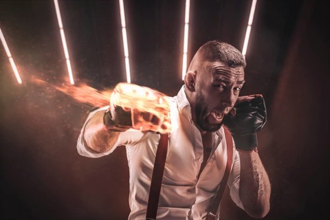 Image of a brutal bearded man boxing in sports pads. Mixed martial arts. The concept of fist fights