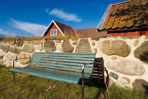 Park bench, bench, wooden bench in front of a wooden house in Karlskrona, Sweden