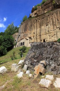 Corbii de Piatra rock monastery, stone ravens carved into a massive, 30-meter high sandstone wall,