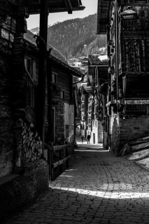 Old farmhouses in the Rue du Village, black and white photo, historic town center, Grimentz, Val