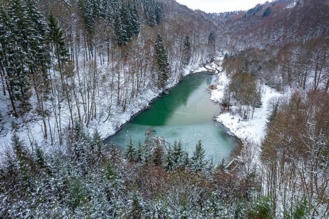 Snow-covered forest and Lake Constance near Winterberg seen from the air, Sauerland, North
