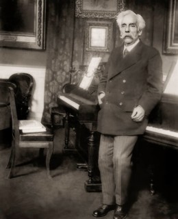 Gabriel Fauré, 1845 – 1924, French composer, next to his piano in his appartement, Boulevard