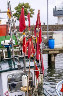 Fishing boats in the town harbour of Sassnitz, island of Rügen, marker buoys for the nets, with red
