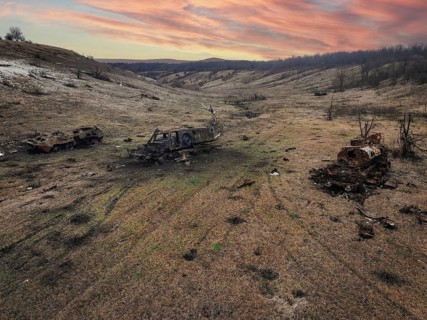 An aerial view showcases the devastating impact of war in a bleak Ukrainian landscape. Burnt out