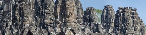 Panoramic image of giant stone-carved faces of the Bodhisattva Lokeshvara, also known as