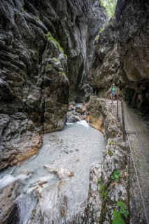 Hammersbach mountain stream in a canyon, mountaineer on a hiking trail in a gorge, Höllentalklamm,