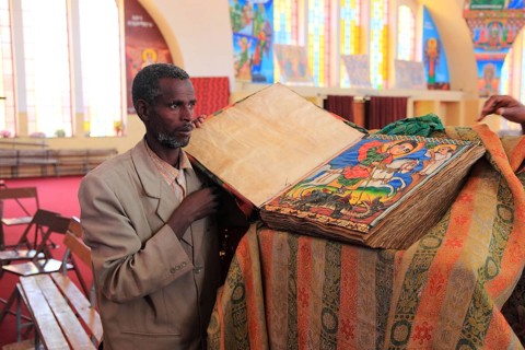 Tigray region, Axum, Aksum, St Mary's Cathedral, Maryam Tsion, inside, church servant shows old