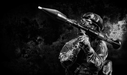 American soldier is aiming at an RPG sight against a dark background. The concept of military