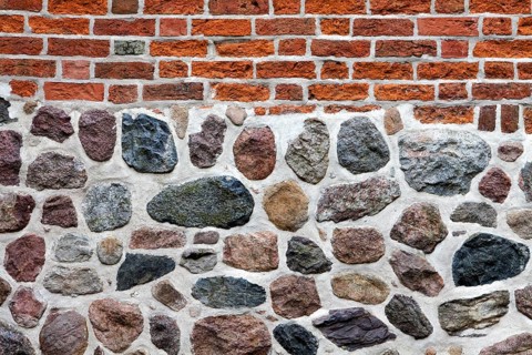 Old stone wall made of erratics rocks and bricks, Church of St. Urbanus, Dorum, Lower Saxony,