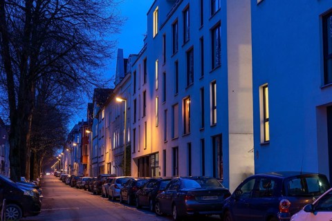 Residential street, many apartment buildings in a residential neighbourhood, evening, lantern