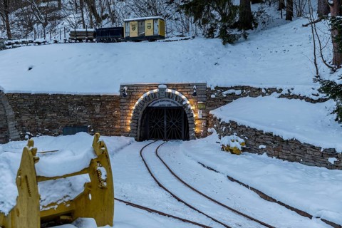 Illuminated mouth hole from the Markus-Röhling-Stolln visitor mine in the snow, template for a