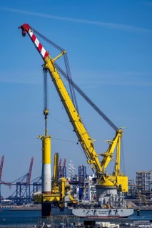 Installation of monopiles, the foundation for offshore wind turbines, here in the port of