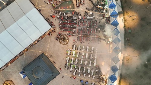 Aerial view captures hundreds of Muslims gathered at long tables for a communal Iftar meal in a