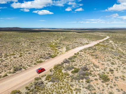 4x4 campervan drives along the road near Estancia la Maciega, Chubut, Argentina
