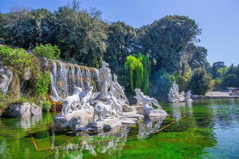 Fountain sculptures at the water basins in the garden of the royal palace Palazzo Reale, Italian