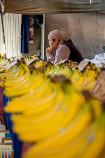 Fruit stall, woman selling bananas at the Osh bazaar, Bishkek, Kyrgyzstan