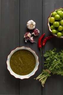 Tkemali sauce, traditional Georgian cuisine, green cherry plum, with ingredients for sauce,
