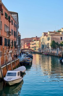 View from 'Fondamenta del rio novo' on a waterway with boats lying in the water in Venice on a