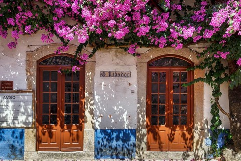 Façade decorated with flowers in the medieval village of Óbidos, Portugal