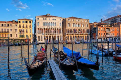 Grand Canal with boats and gondolas on sunset, Venice, Italy