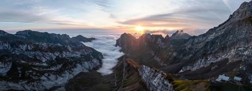 View over Säntis mountains into the valley of Meglisalp at sunrise, high fog in the valley, Säntis,