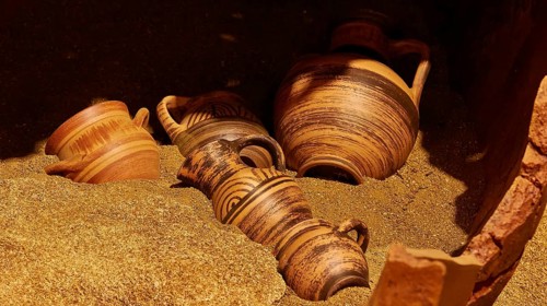 Tomb urns, Protogeometric period, several ancient clay vessels with patterns on sandy ground, Pylos