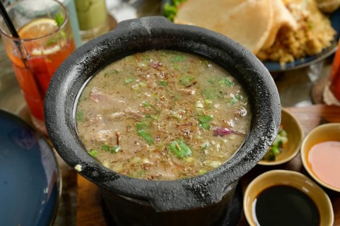 A close-up image of Sop Khas Tanah Abang, a traditional Betawi soup made from goat meat, legs, and