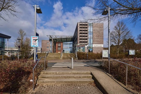 Town hall, stairs, stainless steel railing, lantern, street, blue sky with cumulus clouds, town