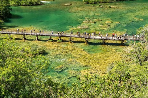 Tourists on the pedestrian bridge over the Krka River in Krka National Park, Croatia