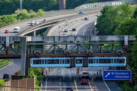 The Wuppertal suspension railway, train of the latest generation 15, crosses the A46 motorway,