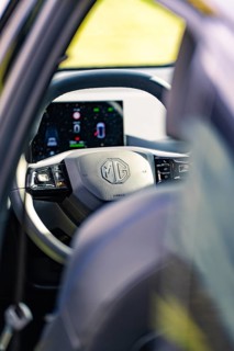 View of the steering wheel of a car and control elements, with visible screen, e-car sharing, Deer
