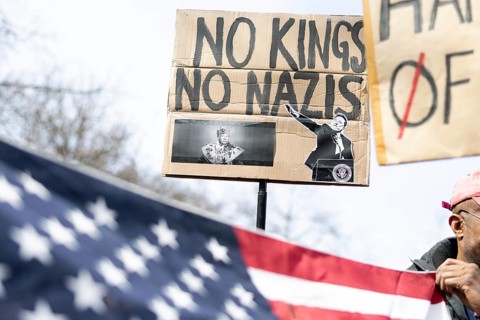 Berlin, Germany - 5 April 2025: A demonstrator holds a sign with the inscription No Kings No Nazis