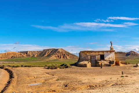 Old abandoned building standing in the arid landscape of bardenas reales desert in navarre, spain,