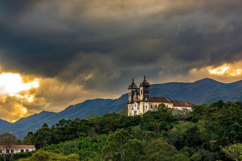 Baroque church and mountains of the city of Ouro Preto in Minas Gerais during sunset, Ouro Preto,