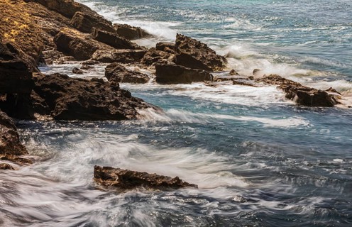 Rugged rocky coastline and foaming spray, on Stecci beach, near Capoliveri, Elba Island, Tuscan